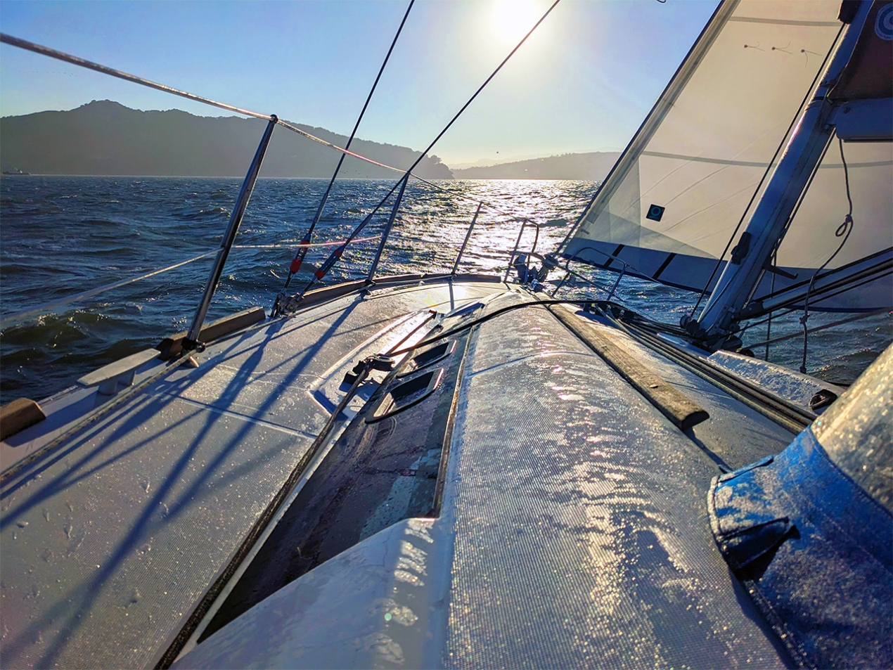 Moisture topside on deck of a sailboat heading into the sunrise at Modern Sailing Berkeley by Jayson Fennimore